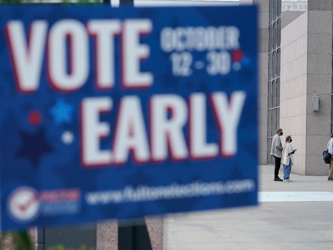 A line forms outside of the State Farm Arena for early voting on Monday in Atlanta.