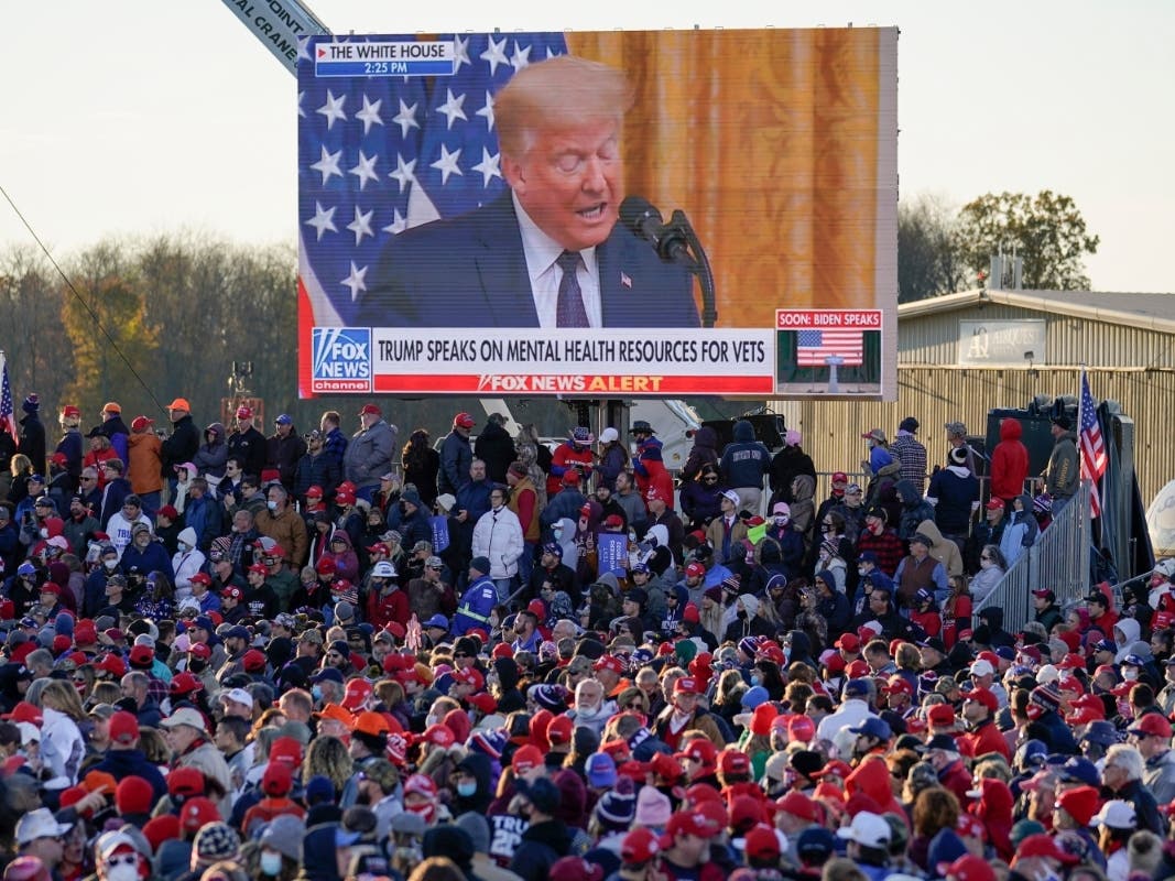A throng of supporters listen to a video message as they await the arrival of President Donald Trump at the Butler County Regional Airport in Butler, Pennsylvania, Saturday. 