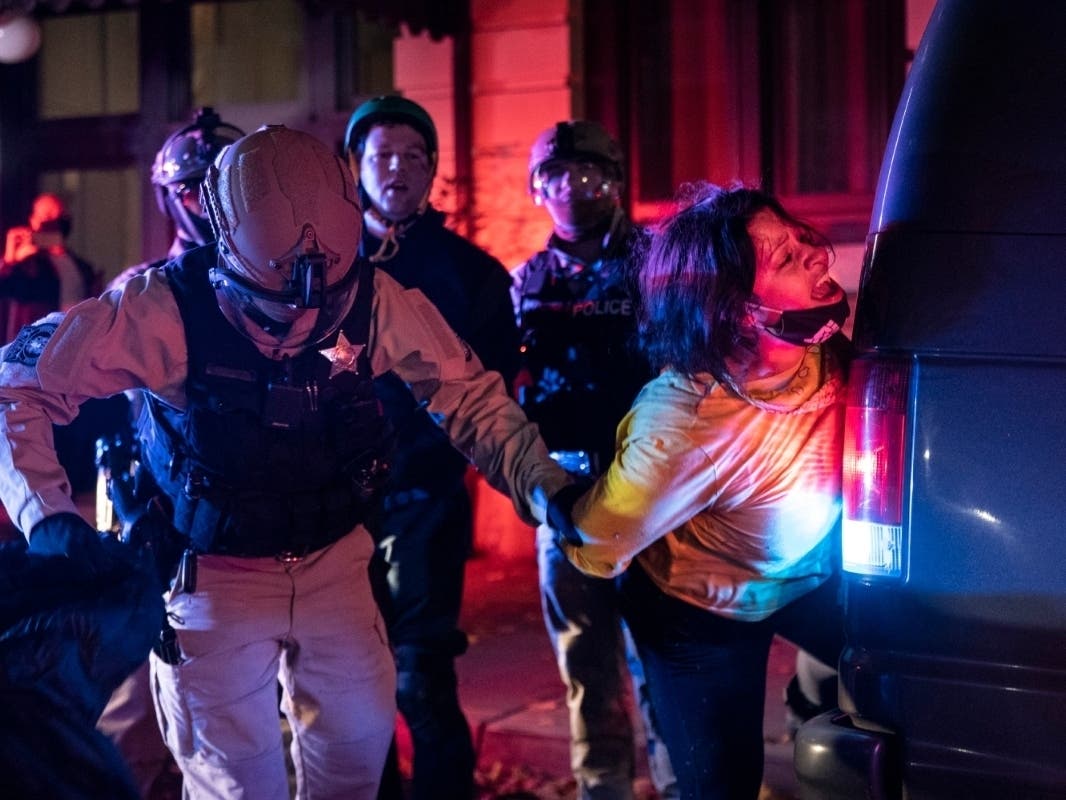 Police arrest a protester during a march in Portland, Oregon, Wednesday after President Donald Trump's baseless claims of widespread voter fraud in the 2020 presidential election.