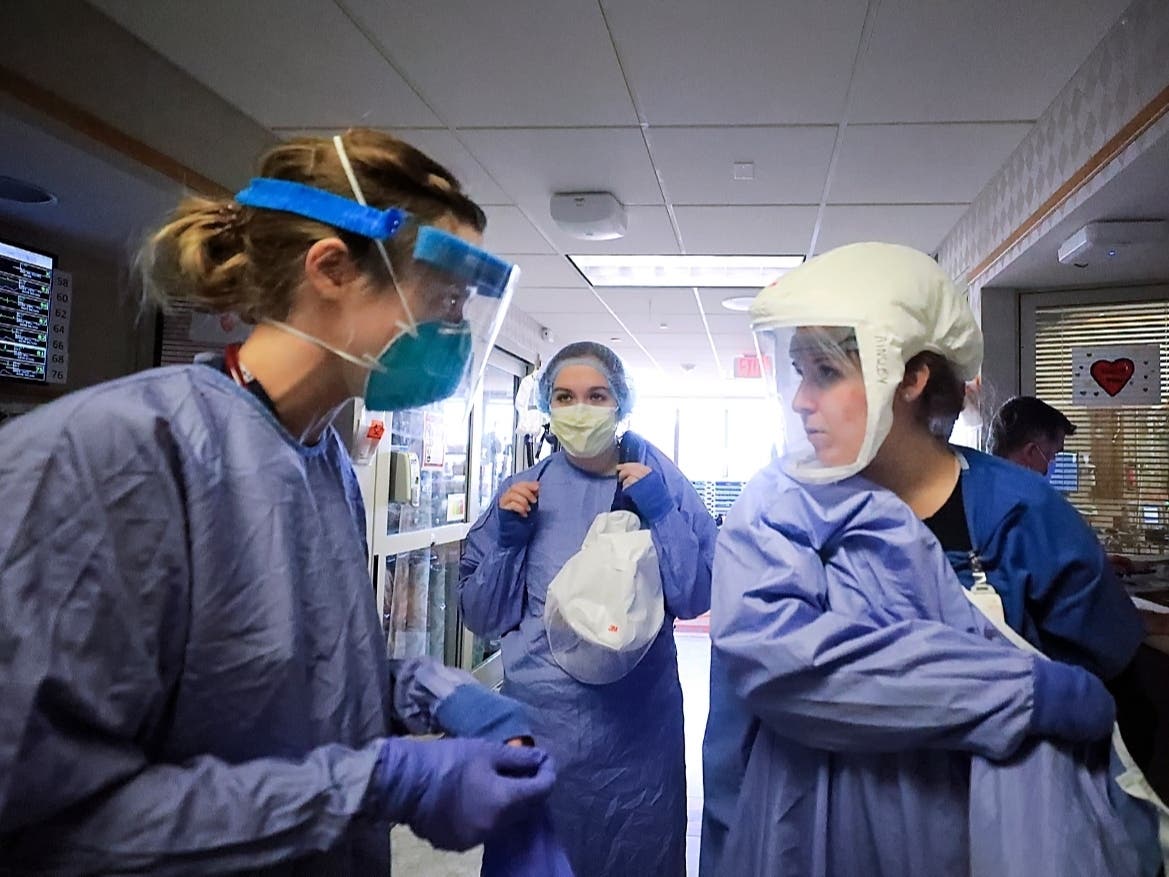 Medical staff attending to patients with COVID-19 wear protective equipment in a unit dedicated to treatment of the coronavirus at UW Health in Madison, Wisconsin. 