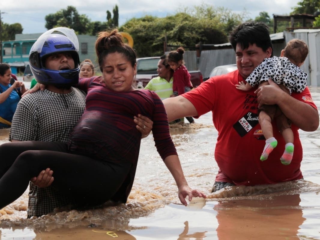 A pregnant woman is among those rescued from floodwaters brought by Hurricane Eta in Planeta, Honduras. The infamous gang violence there has not relented, and some Hondurans said gangs were charging a tax to boats trying to rescue people. ​