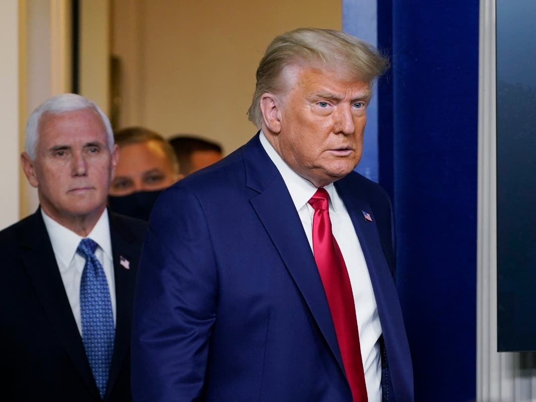 President Donald Trump walks out to speak in the Brady Briefing Room in the White House Tuesday in Washington, with Vice President Mike Pence.