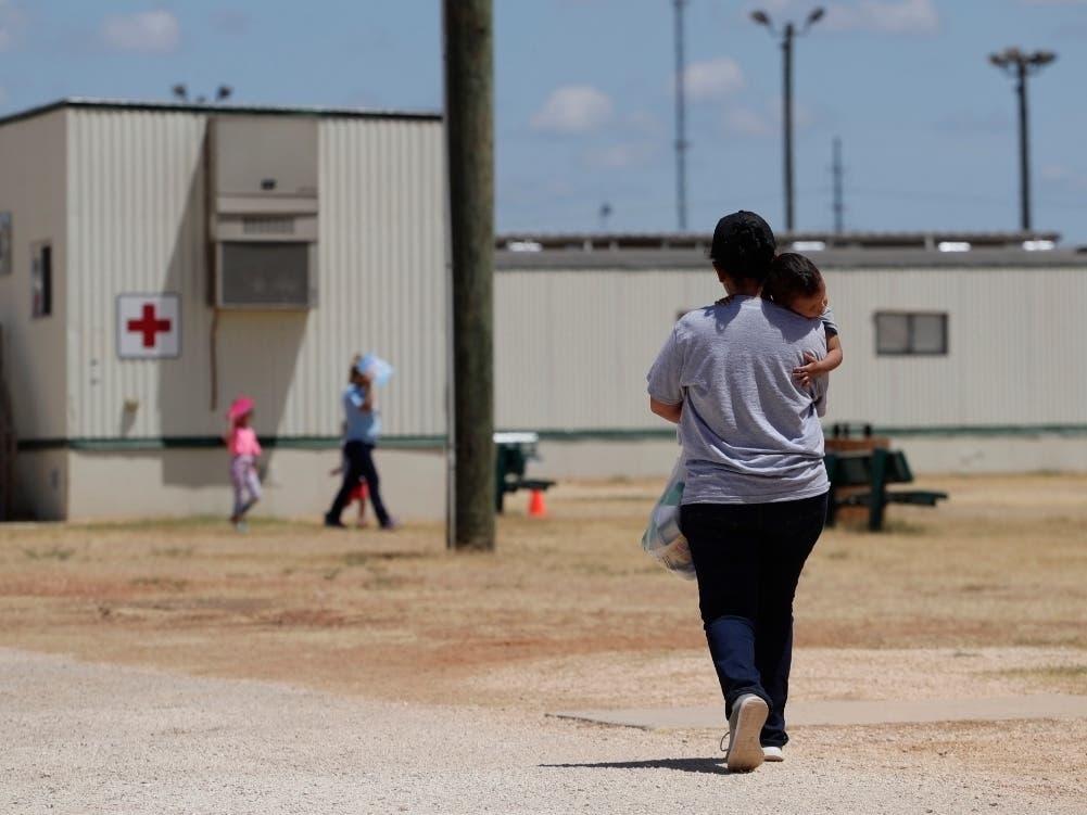 Immigrants seeking asylum walk at the ICE South Texas Family Residential Center, in Dilley, Texas.
