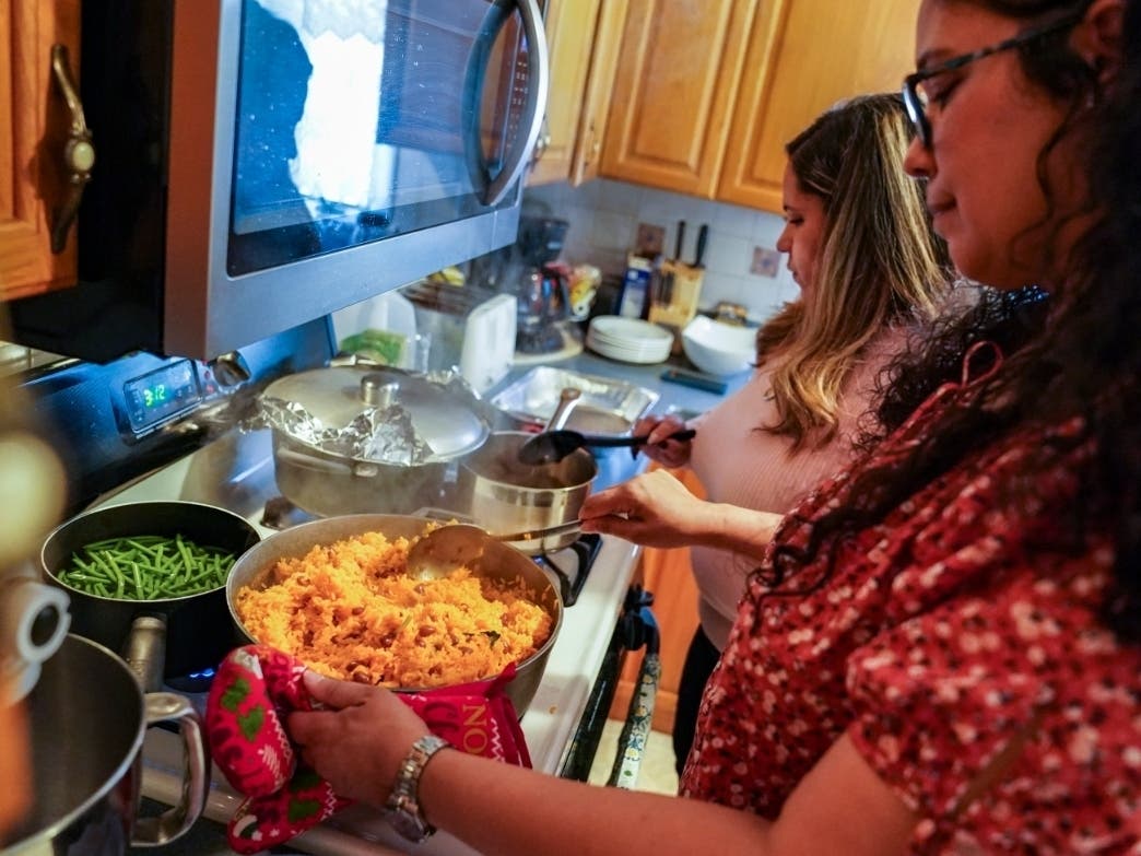 Vivian Zayas cooks rice and beans by her mother's recipe, the recently deceased Ana Martinez, as she and her sister Alexa prepare Thanksgiving dinner,.Virus Outbreak Altered Thanksgiving