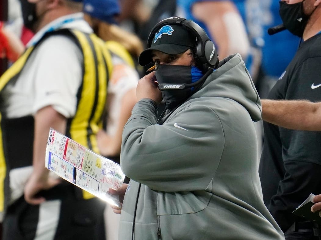 Detroit Lions head coach Matt Patricia adjusts his face mask during the second half of an NFL football game against the Houston Texans.
