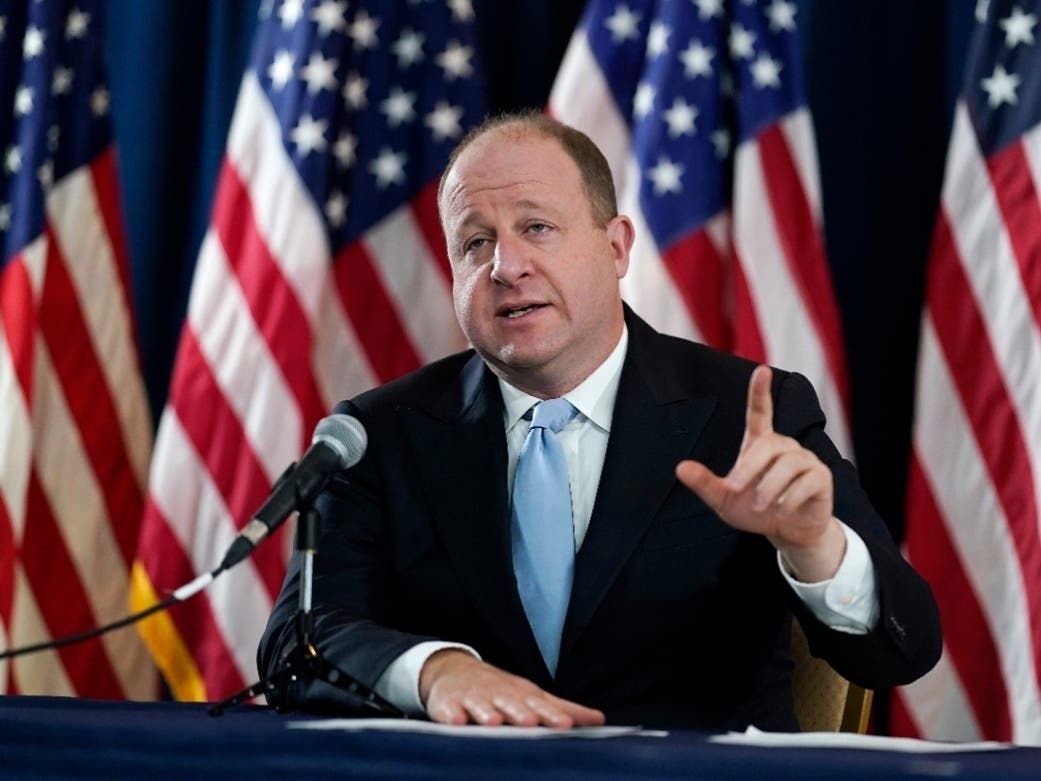 Colorado Gov. Jared Polis speaks during a news conference about the state's response to the rapid increase in COVID-19 cases.