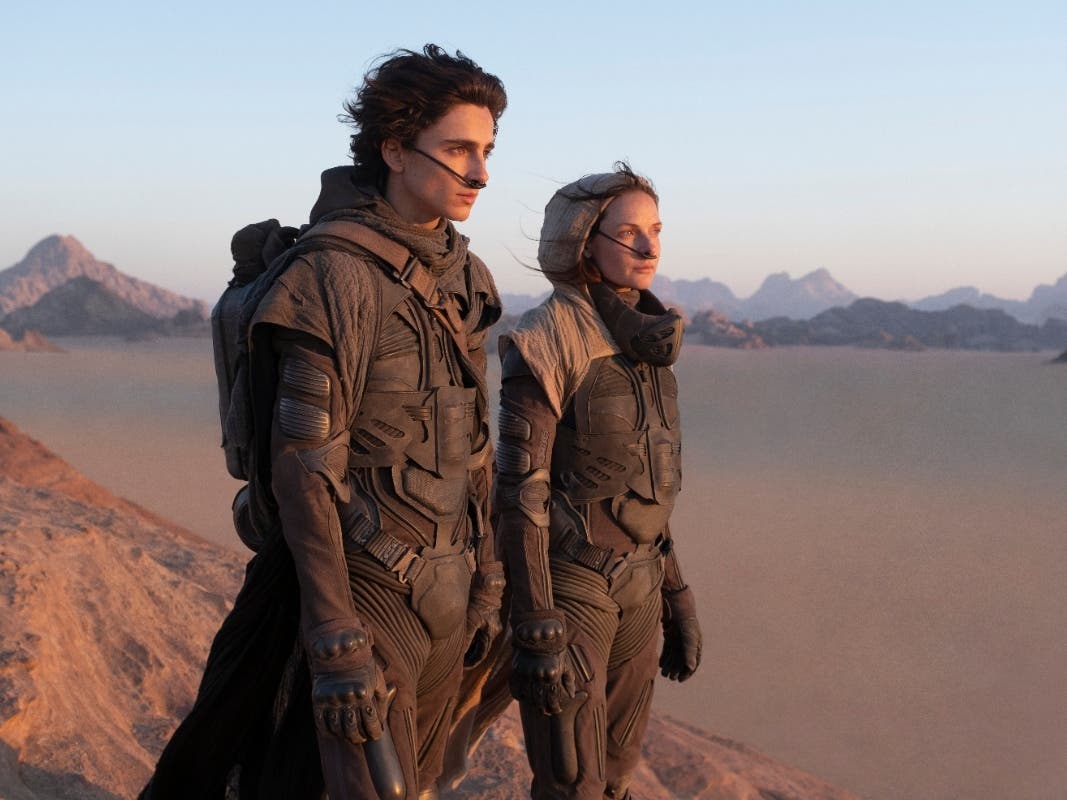 This image released by Warner Bros. Entertainment shows Timothee Chalamet, left, and Rebecca Ferguson in a scene from the upcoming 2021 film "Dune."