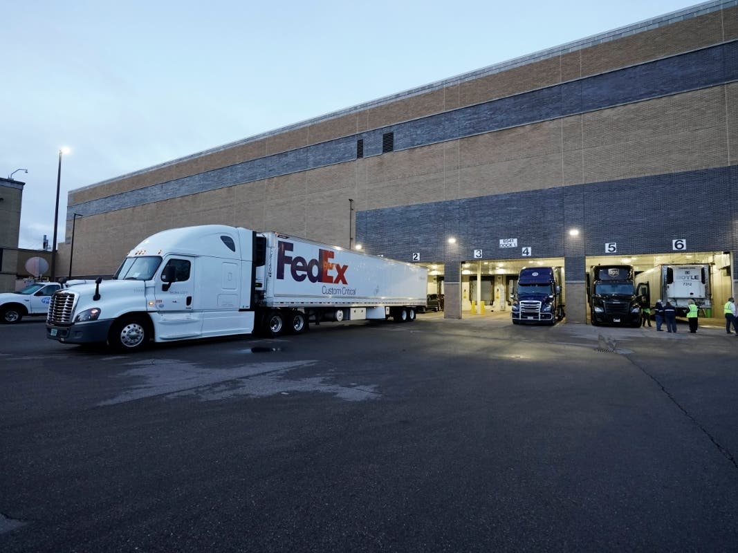 A truck loaded with the Pfizer-BioNTech COVID-19 vaccine leaves the Pfizer Global Supply Kalamazoo manufacturing plant in Portage, Michigan.