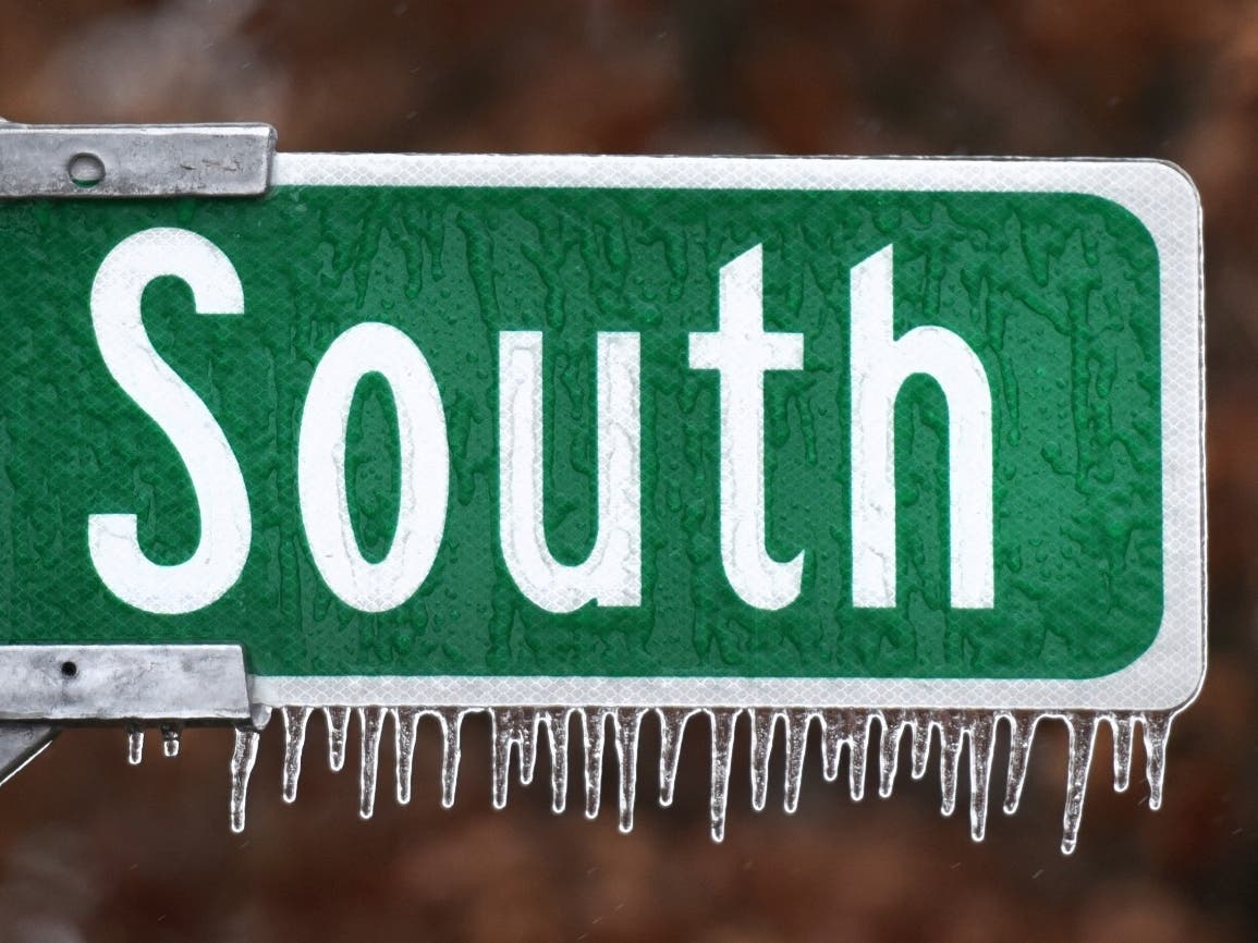 Ice clings to a highway sign along N.C. Highway 66 South in Kernersville, N.C., as the Triad area experienced a light case of freezing rain, Wednesday.