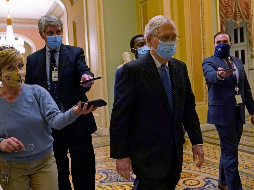 Senate Majority Leader Mitch McConnell, R-KY., walks past reporters on Capitol Hill in Washington on Tuesday.