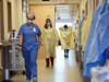 Nurses and medical staff make their way through the seventh floor COVID-19 unit at East Alabama Medical Center Thursday, Dec. 10 in Opelika, Alabama. COVID-19 patients occupy most of the beds in ICU in addition to the non-critical patients.