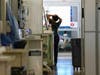 Susan Randolph, a medical worker at East Alabama Medical Center, stretches in the hall of the intensive care unit on Thursday, Dec. 10.