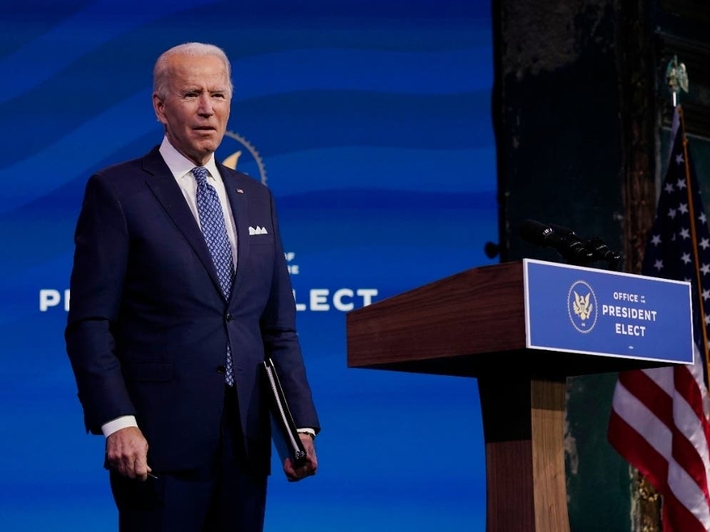President-elect Joe Biden pauses as he leaves to listen to a reporter's shouted question at The Queen Theater in Wilmington, Delaware on Tuesday, Dec 22.