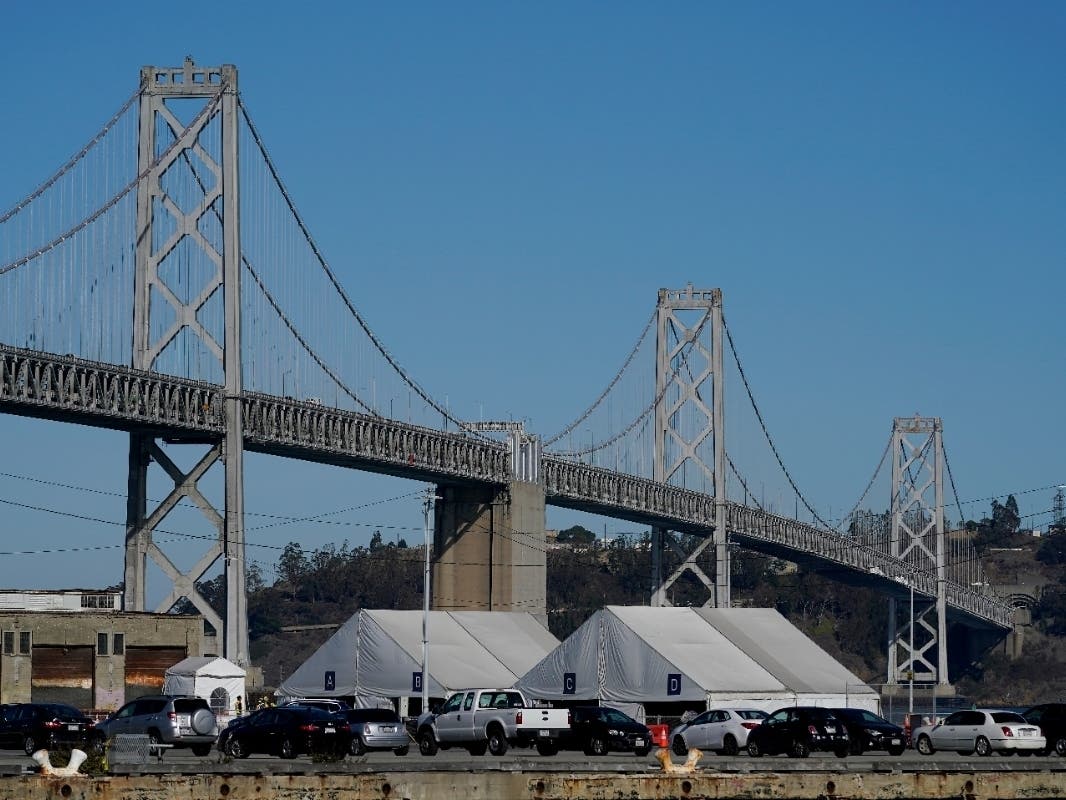 Tents from the CityTestSF at Pier 30/32 COVID-19 testing site sit in front of the San Francisco-Oakland Bay Bridge during the coronavirus pandemic in San Francisco on Wednesday, Dec. 23.