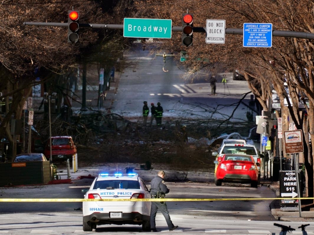 A Nashville Police officer blocks the entrance to the scene of an explosion Saturday, Dec. 26, in Nashville, Tenn. 