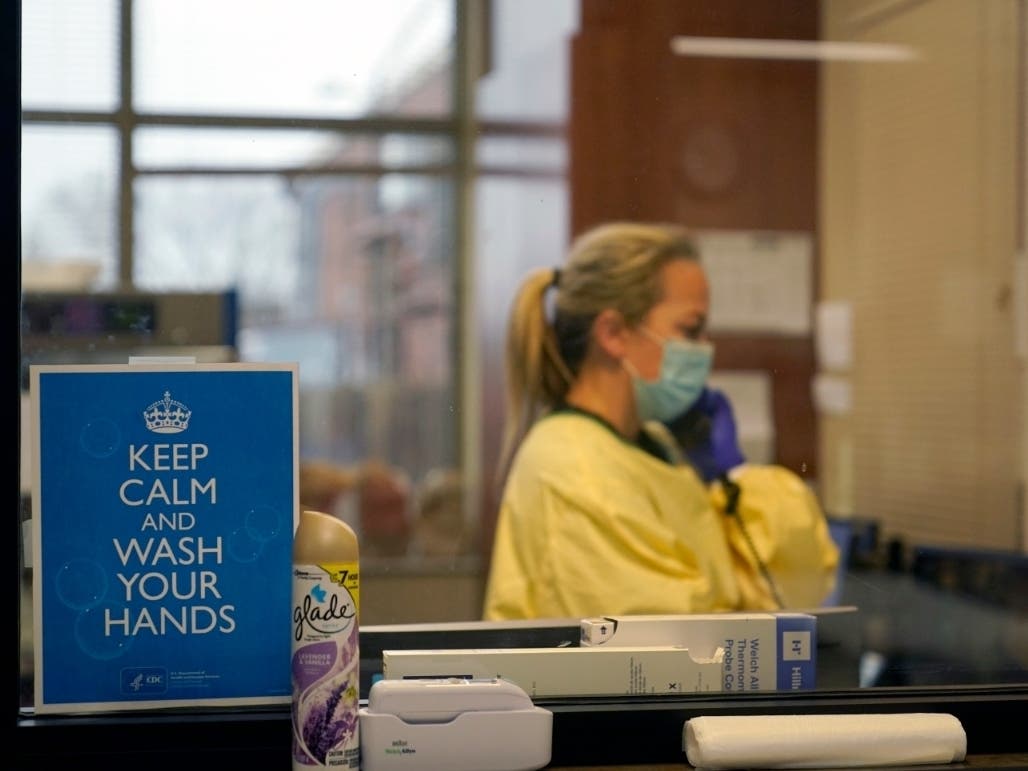 Registered nurse Chrissie Burkhiser, an emergency room nurse at Scotland County Hospital in Memphis, Missouri, continue to be overwhelmed in the care of COVID-19 as a new strain of the virus causing the illness is confirmed in Colorado and California.