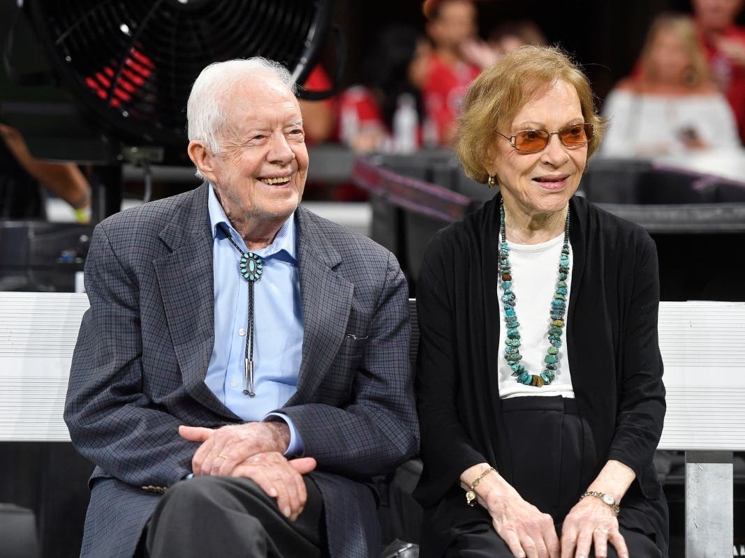 Former President Jimmy Carter and Rosalynn Carter are seen ahead of an NFL football game between the Atlanta Falcons and the Cincinnati Bengals in Atlanta in 2018.