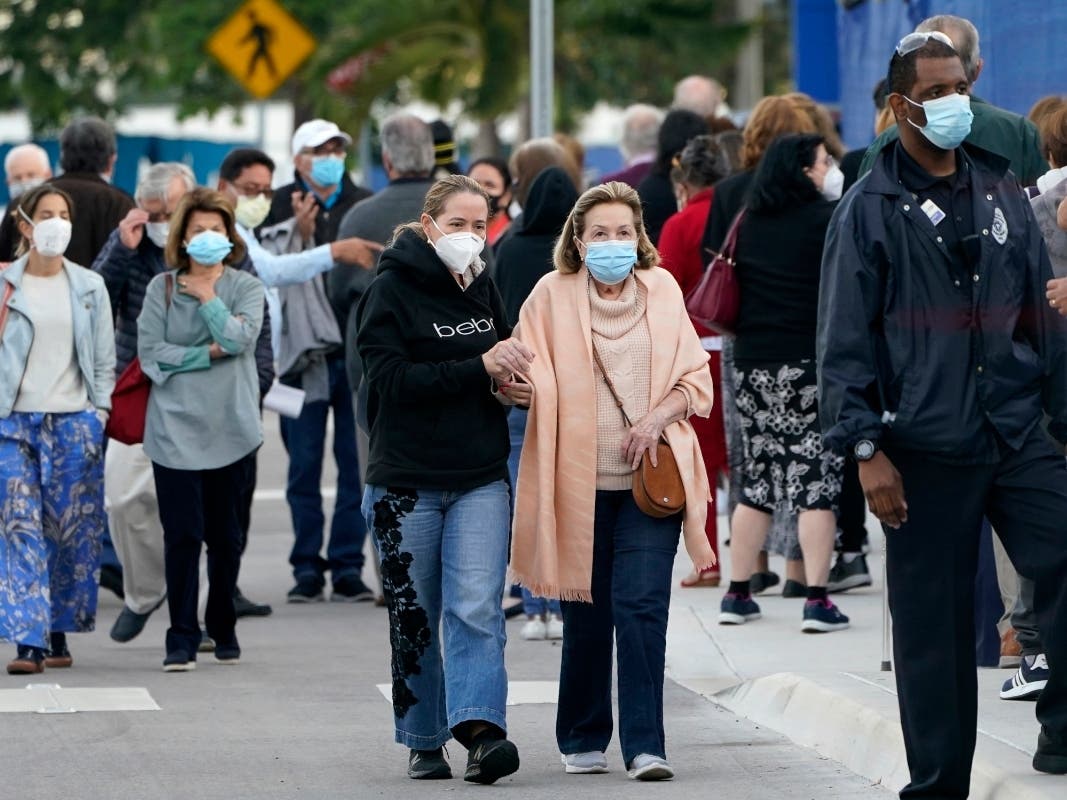 People arrive at Jackson Memorial Hospital to receive the COVID-19 vaccine in Miami. 
