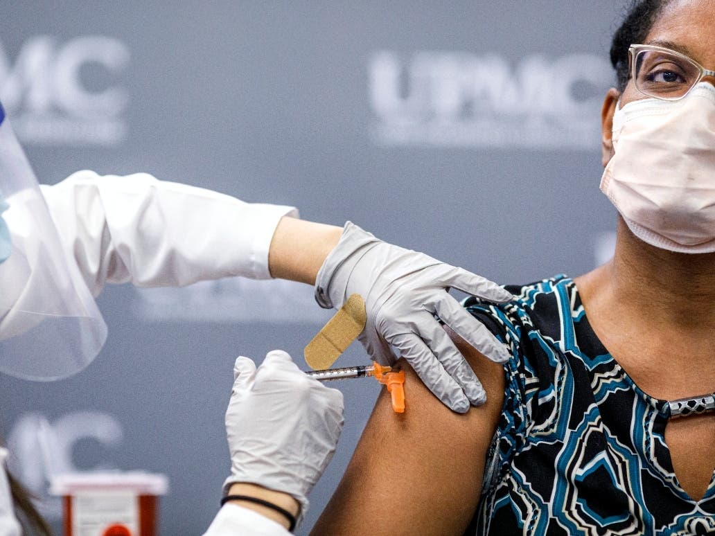 Jill Johnson adminsters the Pfizer COVID-19 vaccine to Sharee Livingston, an OB-GYN with UPMC Lititz. UPMC frontline workers receive the first doses of the Pfizer COVID-19 vaccine at UPMC Pinnacle Harrisburg hospital on Dec. 18.