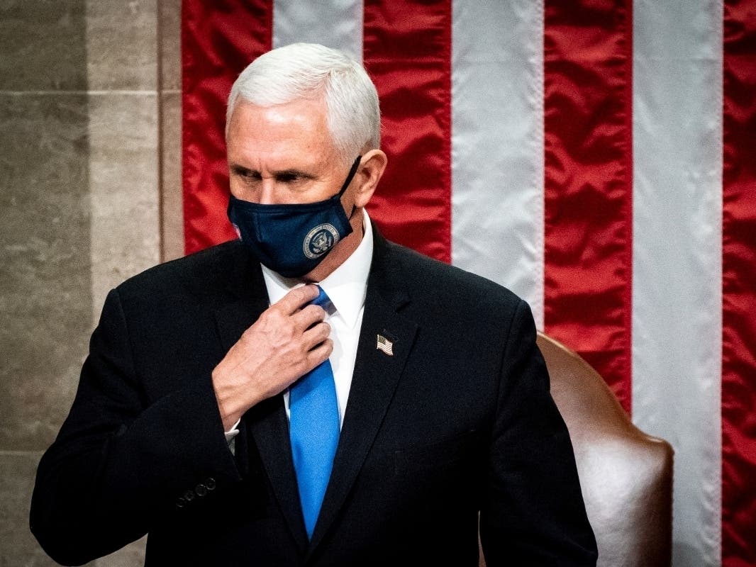 Vice President Mike Pence officiates as a joint session of the House and Senate reconvenes to confirm the Electoral College votes at the Capitol on Jan 6.