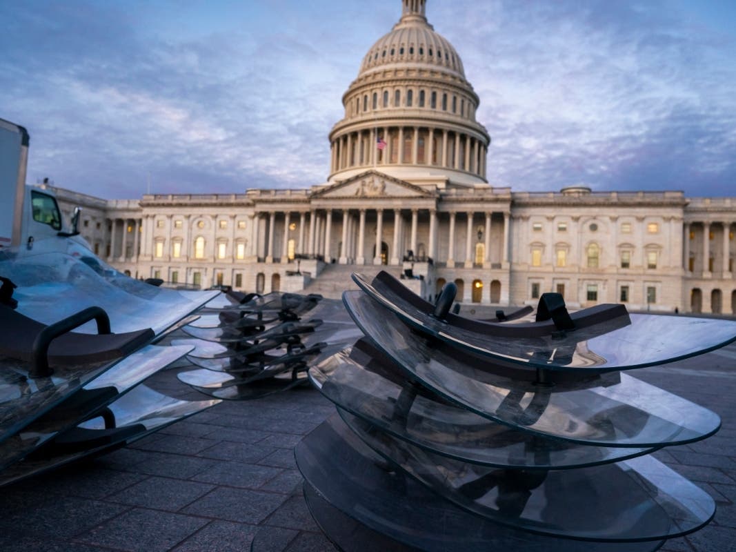 Riot shields are stacked at the ready as National Guard troops reinforce the security zone on Capitol Hill in Washington Tuesday before President-elect Joe Biden is sworn in as the 46th president on Wednesday.