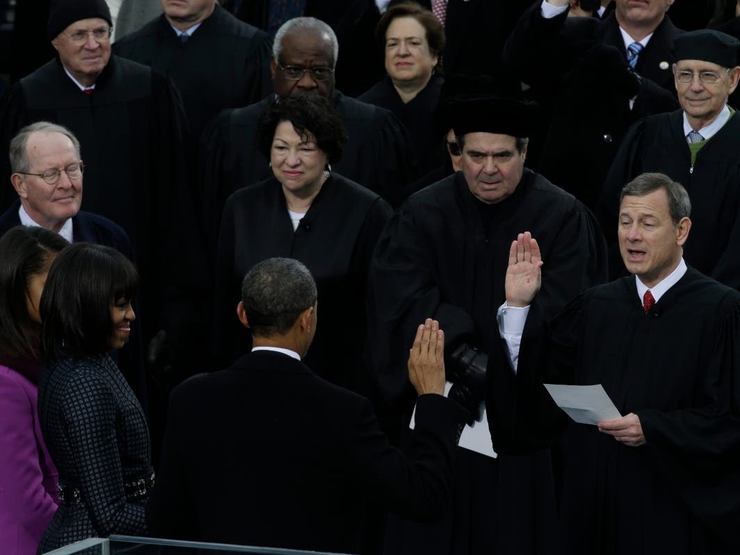 In this Jan. 21, 2013, file photo Chief Justice John Roberts, right, reads the oath of office to President Barack Obama at the ceremonial swearing-in at the U.S. Capitol during the 57th Presidential Inauguration in Washington. 