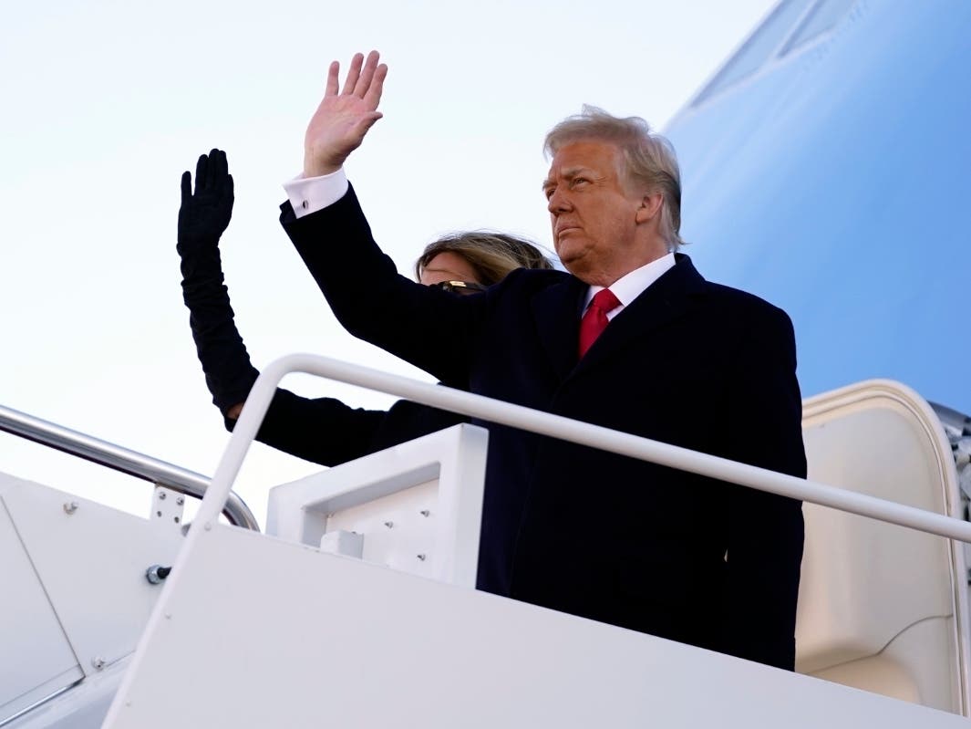 President Donald Trump and first lady Melania Trump board Air Force One at Andrews Air Force Base, Md., Wednesday, Jan. 20, 2021.