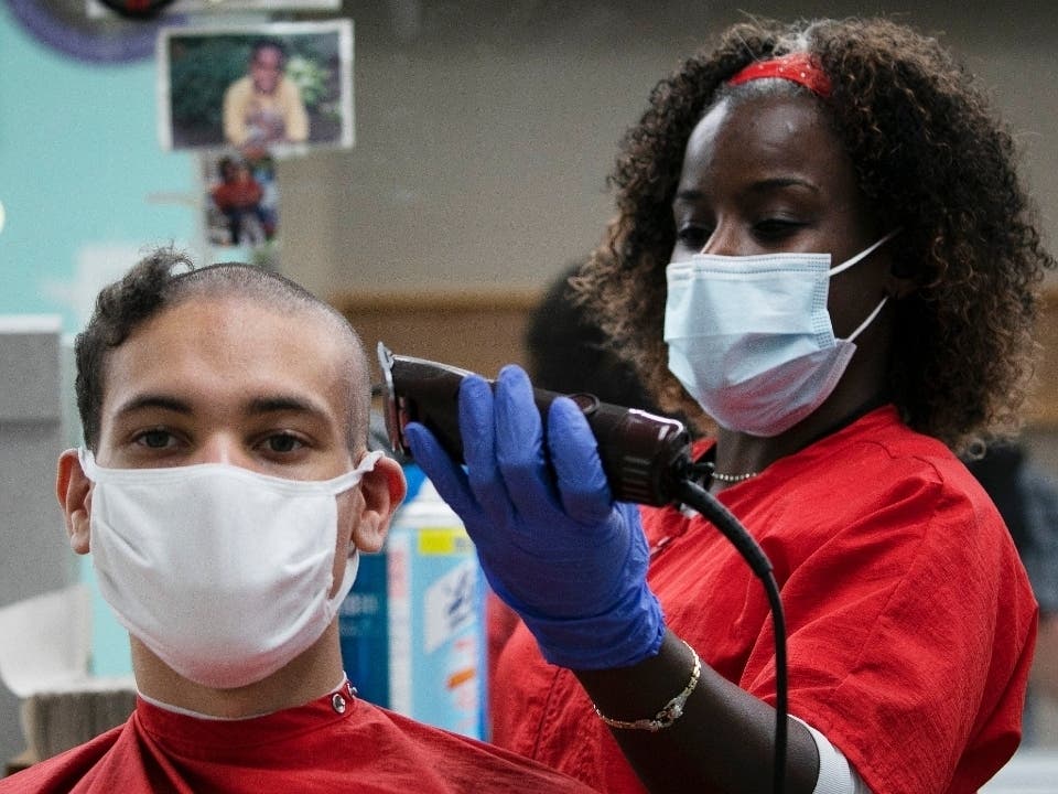 Noah Petty, of Boise, Idaho, has his hair cut by Jeanine Jennings on his first day at the U.S. Military Academy in West Point, New York. Female soldiers can let their hair down and flash nail color under new rules, but male soldiers still have to shave.