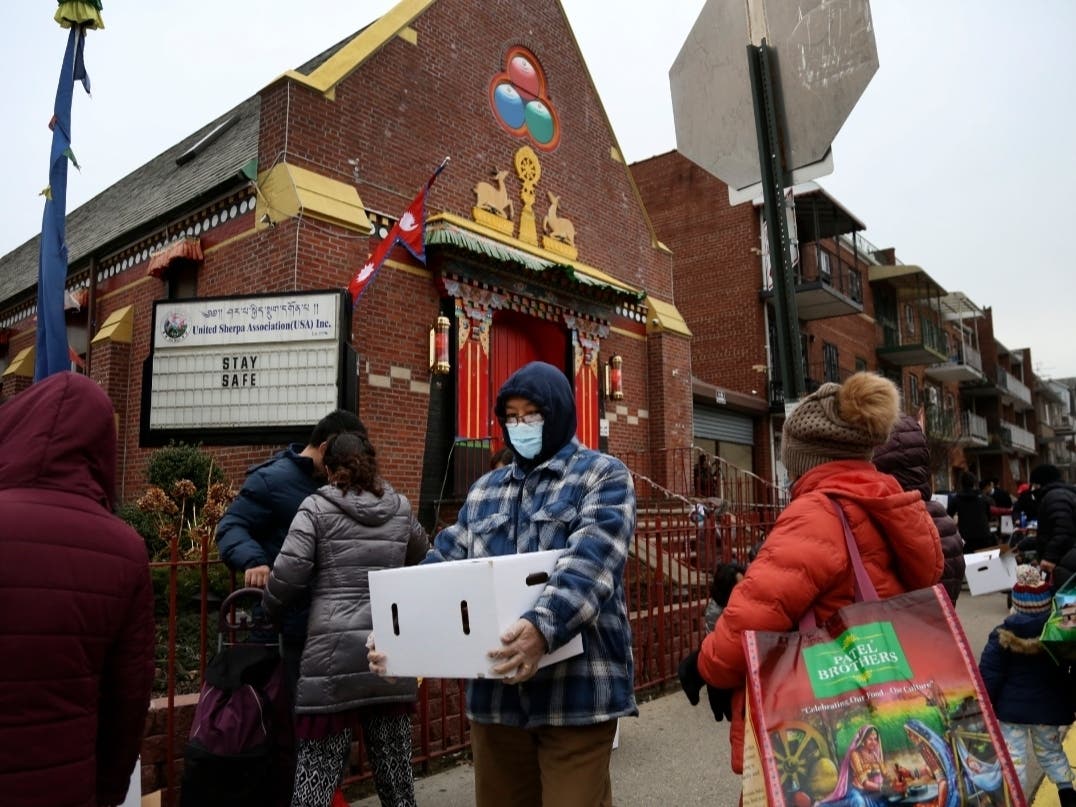 People receive free food from the United Sherpa Association's weekly food pantry on Friday, Jan. 15, 2021.