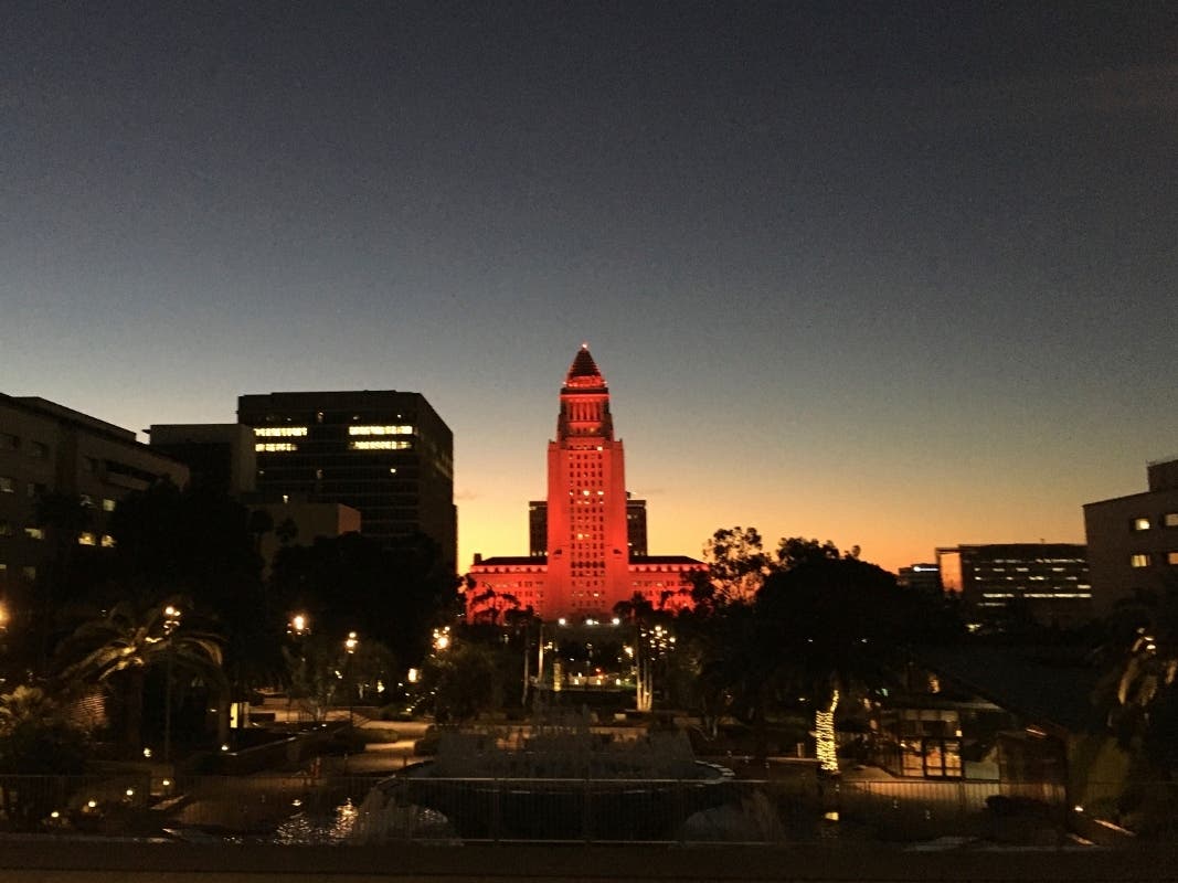 Los Angeles City Hall glows red at dawn Friday, Feb. 19, 2021, in honor of the Mars rover Perseverance's landing on the red planet. 