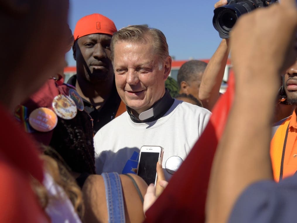 The Rev. Michael Pfleger is shown speaking to protesters before marching on the Dan Ryan Expressway in Chicago in 2018. A third man has come forward with allegations that Rev. Pfleger made an unwanted sexual advance against him as a teenager.
