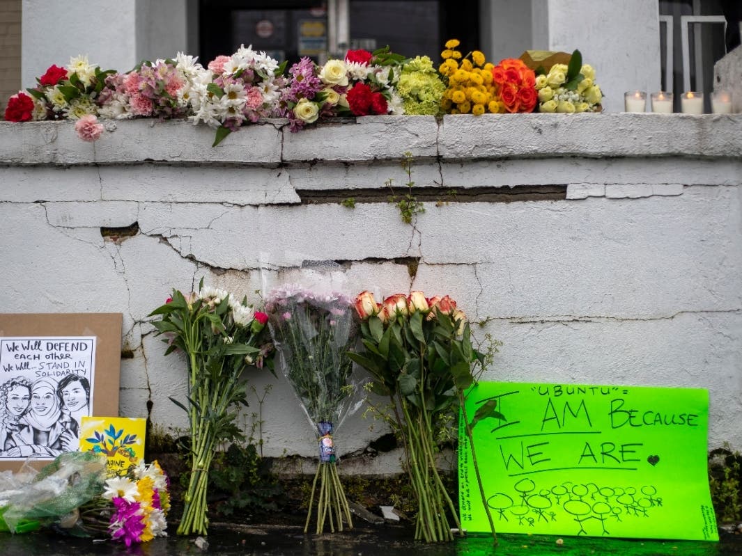 Flowers and signs are displayed at a makeshift memorial outside of the Gold Spa in Atlanta, Wednesday, March 17, 2021. 