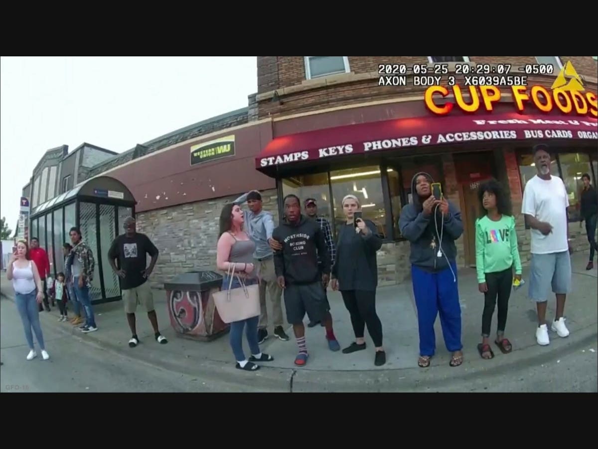 This image from a police body camera shows people gathering as former Minneapolis police officer Derek Chauvin was recorded pressing his knee on George Floyd's neck for several minutes as onlookers yelled at Chauvin to get off.
