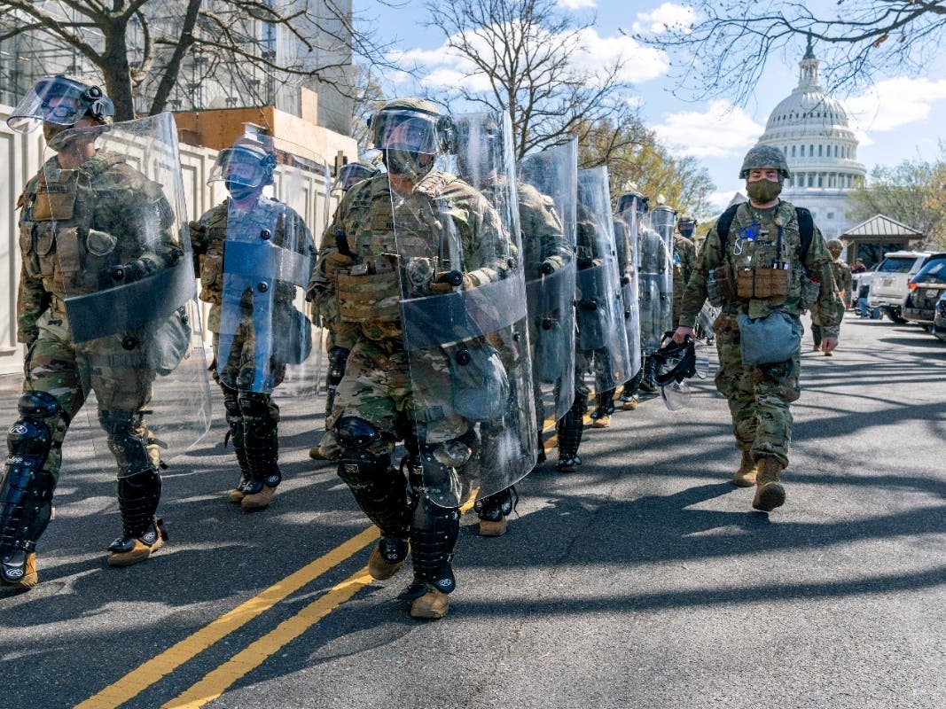 Members of the National Guard leave the Capitol perimeter the they had been guarding, Friday, April 2, after a car crashed into a barrier on Capitol Hill in Washington.