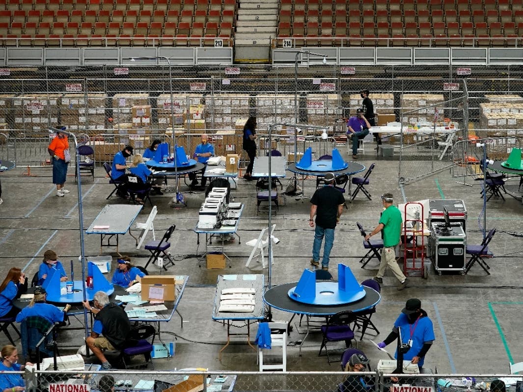 Maricopa County ballots cast in the 2020 general election are examined and recounted by contractors working for Florida-based company, Cyber Ninjas, Thursday, May 6, 2021 at Veterans Memorial Coliseum in Phoenix. 