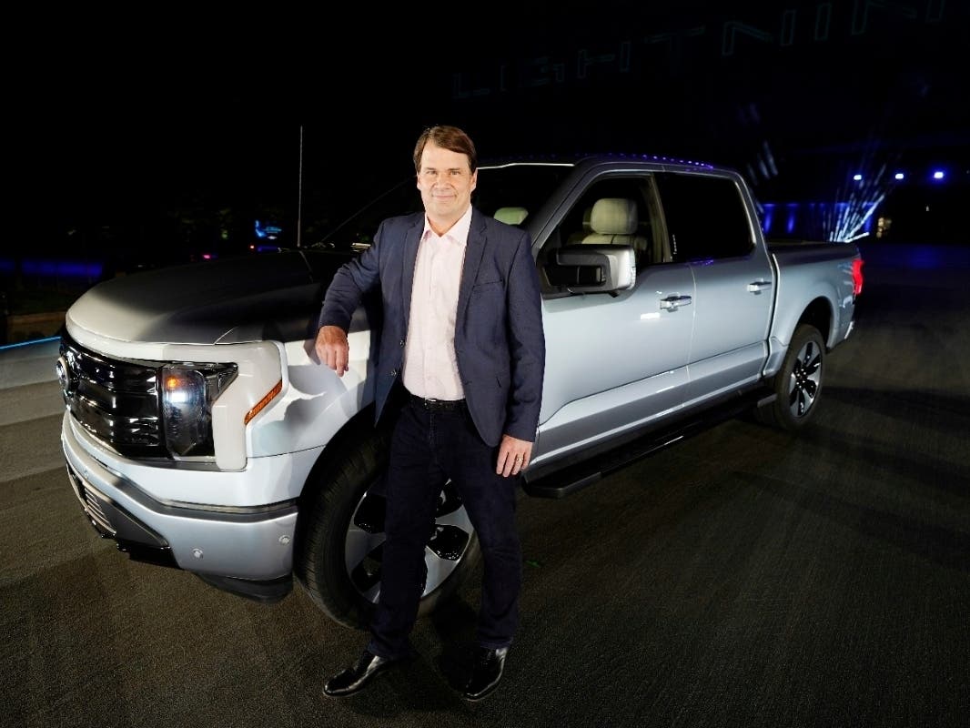 Jim Farley, Ford Motor Company's chief executive officer, stands next to the company's new Ford F-150 Lightning Wednesday in Dearborn.