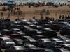 People crowd the Santa Monica Pier in Santa Monica, Calif., Saturday, May 29, 2021. Californians are celebrating the Memorial Day weekend, more upbeat than they have been for any other holiday since the pandemic began.