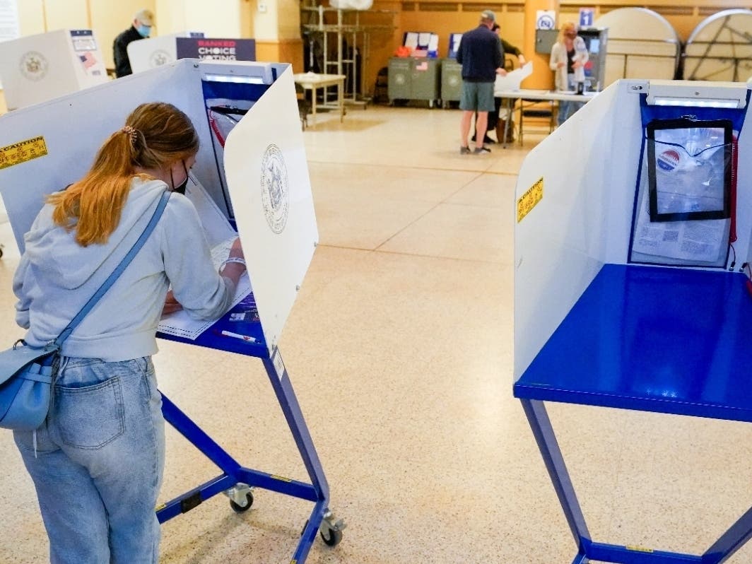 June Harkrider, who turned 18 in March, marks her ballot as she votes for the first time during early voting in the primary election June 14, 2021.