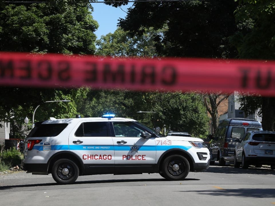 Police tape marks off a Chicago street as officers investigate the scene of a fatal shooting in the city's South Side on Tuesday, June 15. An argument in a house erupted into gunfire early Tuesday, police said.