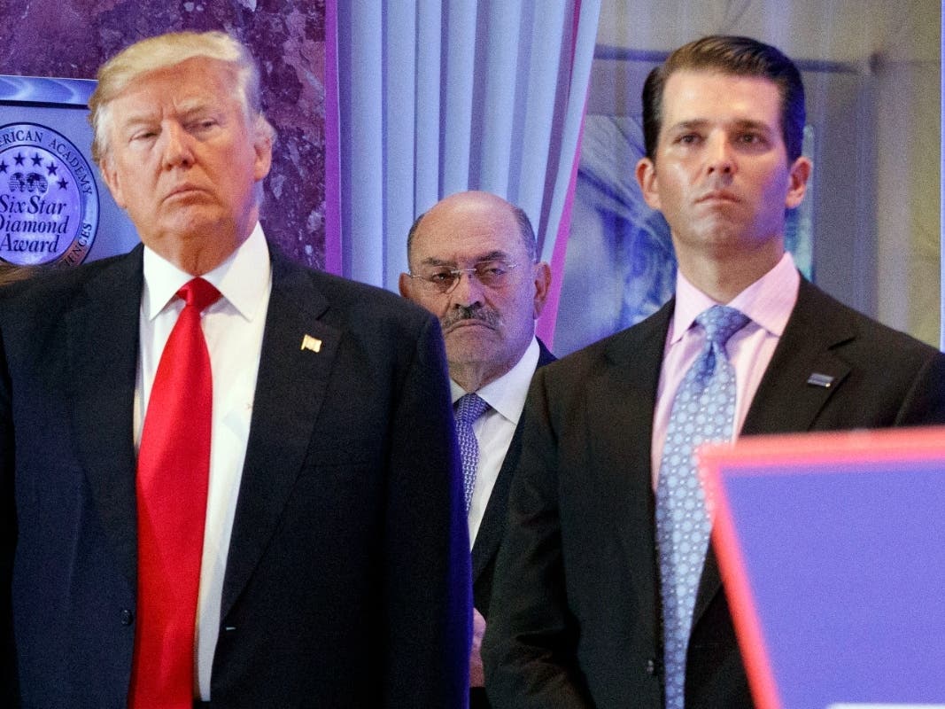  This file photo from Wednesday Jan. 11, 2017, shows President-elect Donald Trump, left, his chief financial officer Allen Weisselberg, center, and his son Donald Trump Jr.