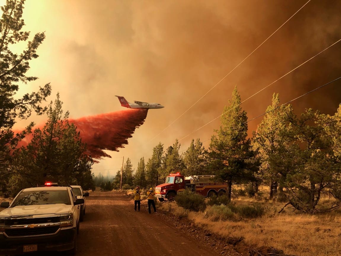 This photo provided by the Oregon Department of Forestry shows a firefighting tanker making a retardant drop over the Grandview Fire near Sisters, Ore., Sunday, July 11.