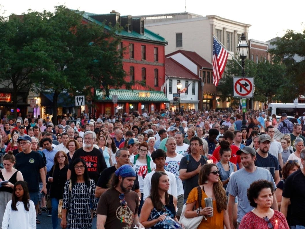 ​People walk in silence during a vigil in response to a shooting in the Capital Gazette newsroom, Friday, June 29, 2018, in Annapolis. On Thursday, a jury found gunman Jarrod W. Ramos was criminally responsible for the deaths of five newspaper employees.