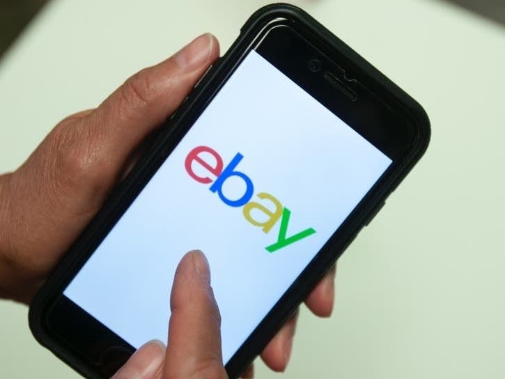 An eBay app is shown on a mobile phone in Miami.