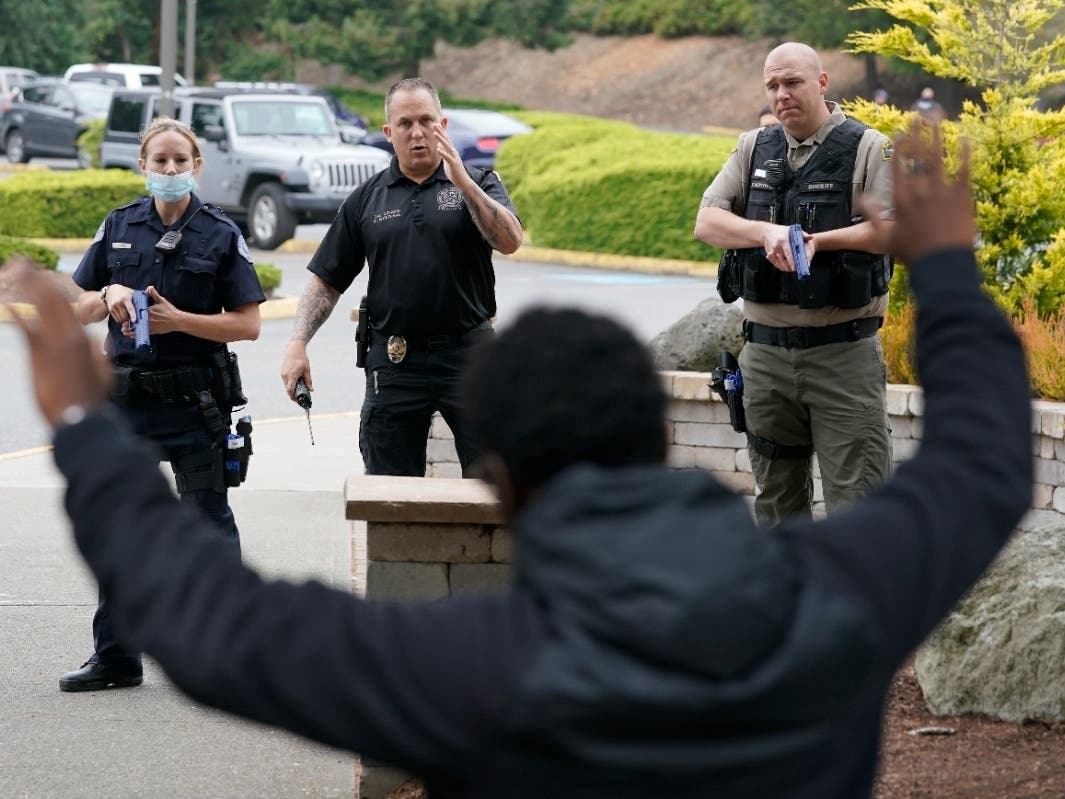 Ken Westphal, center, an instructor at the Washington state Criminal Justice Training Commission, works with cadets LeAnne Cone and Kevin Burton-Crow, right, during a training exercise Wednesday, July 14, 2021, in Burien.