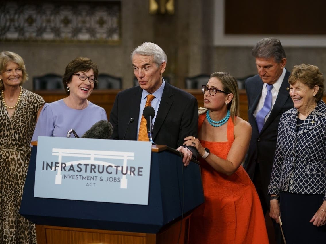 From left, Sen. Lisa Murkowski, R-Alaska; Sen. Susan Collins, R-Maine; Sen. Rob Portman, R-Ohio; Sen. Kyrsten Sinema, D-Arizona; Sen. Joe Manchin, D-West Virginia; and Sen. Jeanne Shaheen, D-New Hampshire speak to reporters Wednesday at the Capitol.