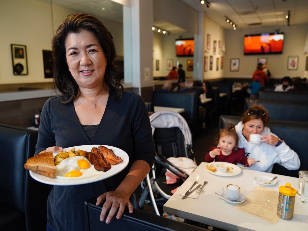 Jeannie Kim holds her popular bacon and eggs breakfast at her restaurant in San Francisco on Friday, July 30, 2021.