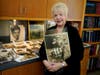 Diane Capone holds a copy of a photograph of her father, Albert "Sonny" Capone as a young boy and her grandfather Al Capone on display at Witherell's Auction House.