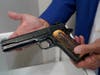 Brian Witherell displays a Colt .45-caliber pistol that once belonged to mob boss Al Capone, at Witherell's Auction House in Sacramento, California.