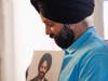 In this Aug. 19, 2016 file photo Rana Singh Sodhi, holds a photograph of his murdered brother, Balbir Singh Sodhi.