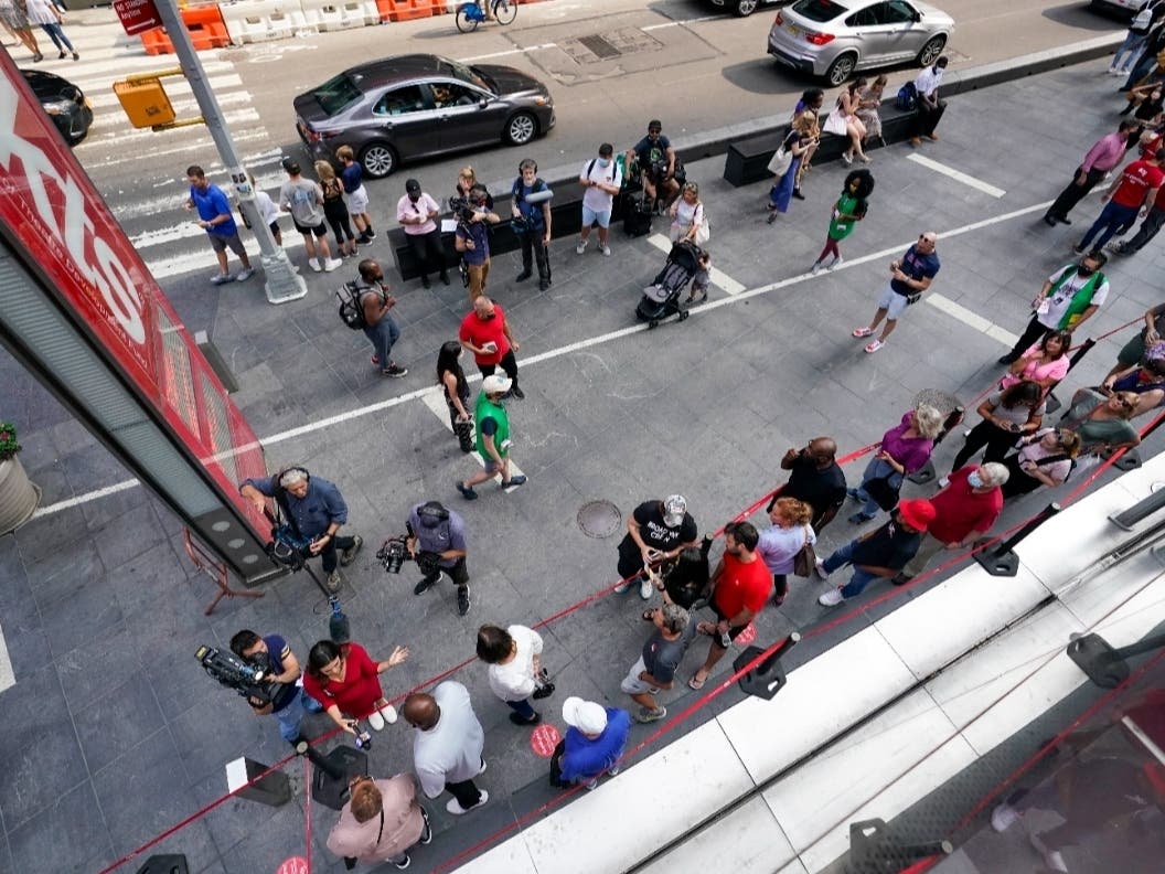 A television crew interviews the first people in line to buy discounted Broadway show tickets at TKTS, Tuesday, Sept. 14, 2021.